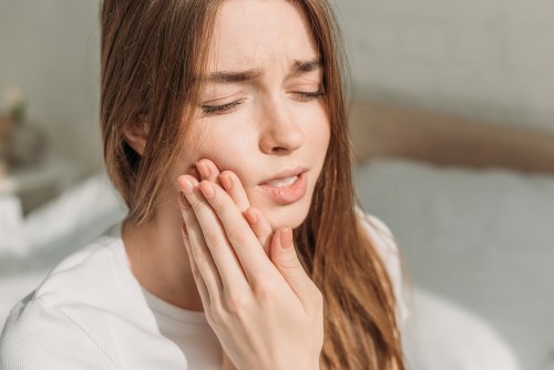 Woman holding her jaw in discomfort