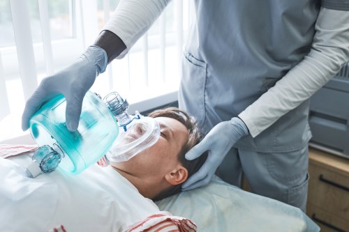 Patient receiving sedation through a mask before a procedure